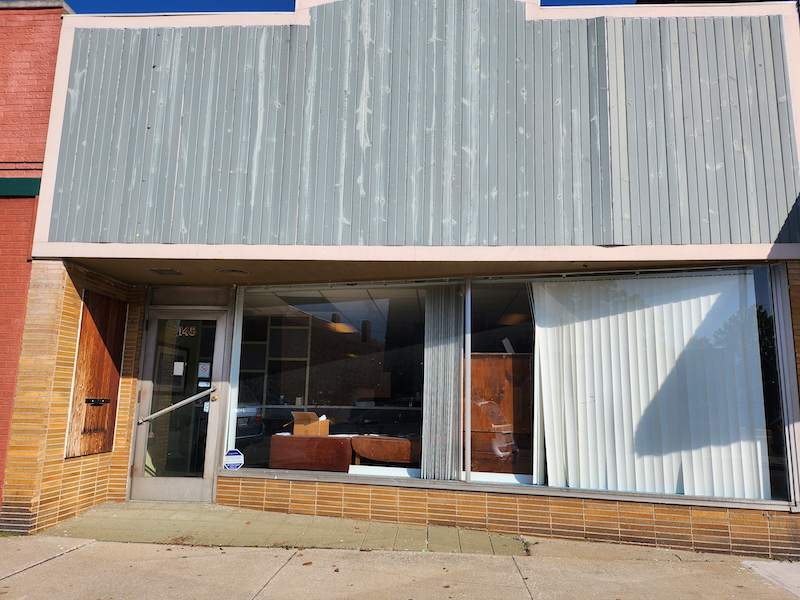 Image of storefront with windows and a door lining the street-facing wall